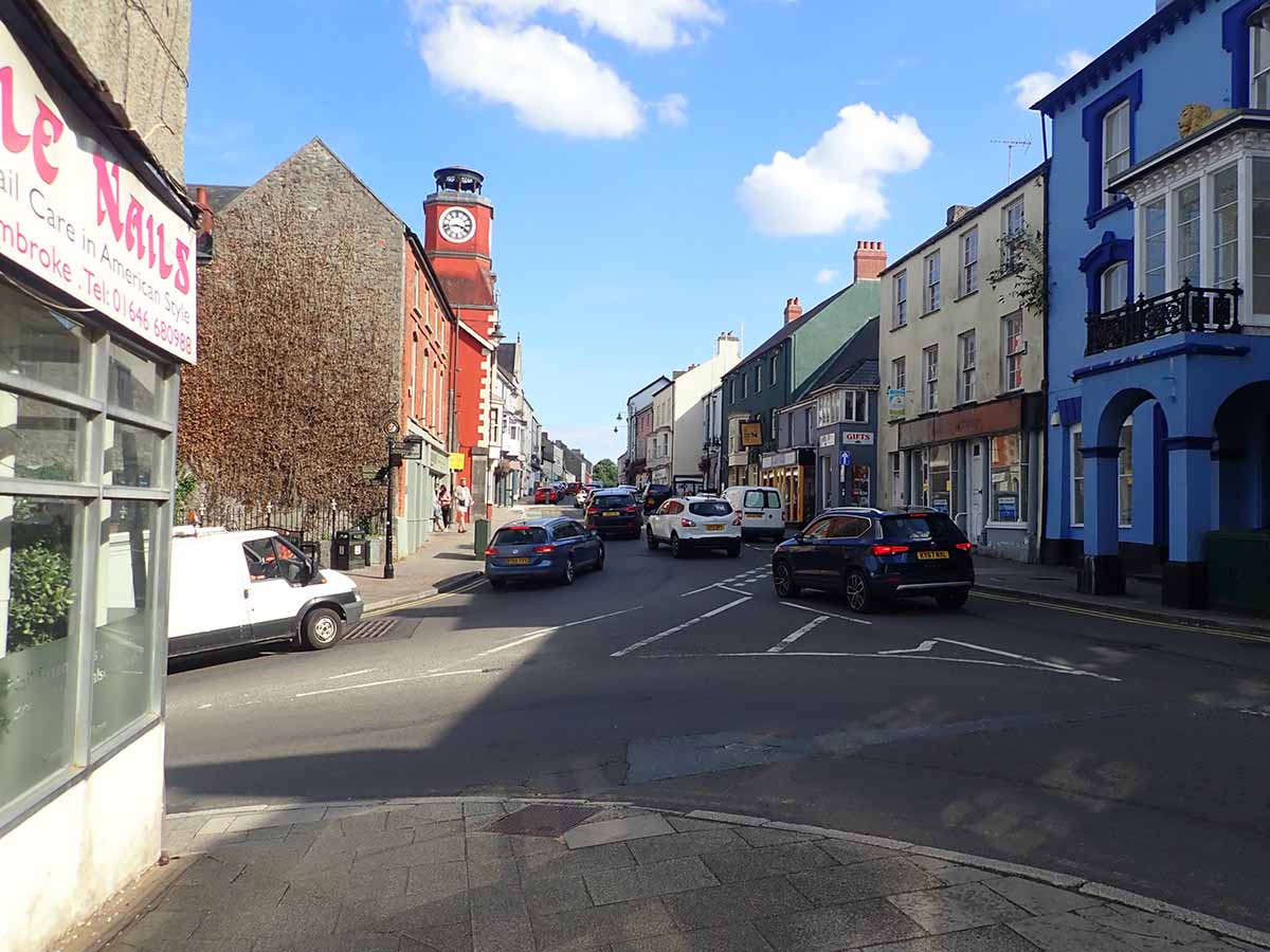 Photo showing pembroke High Street with flats for sale above shops.